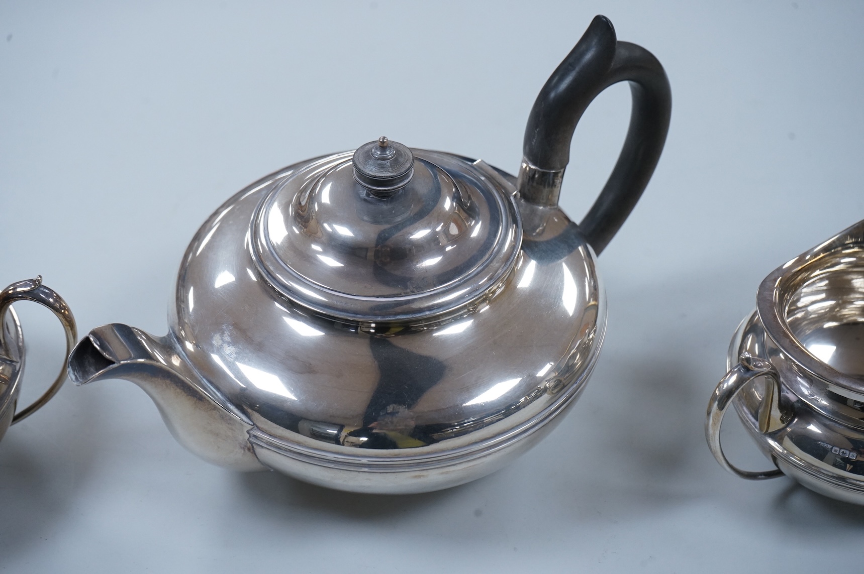 A George V three piece silver tea set, each piece of compressed globular form by James Dixon and Sons, Sheffield 1910, 1025g gross